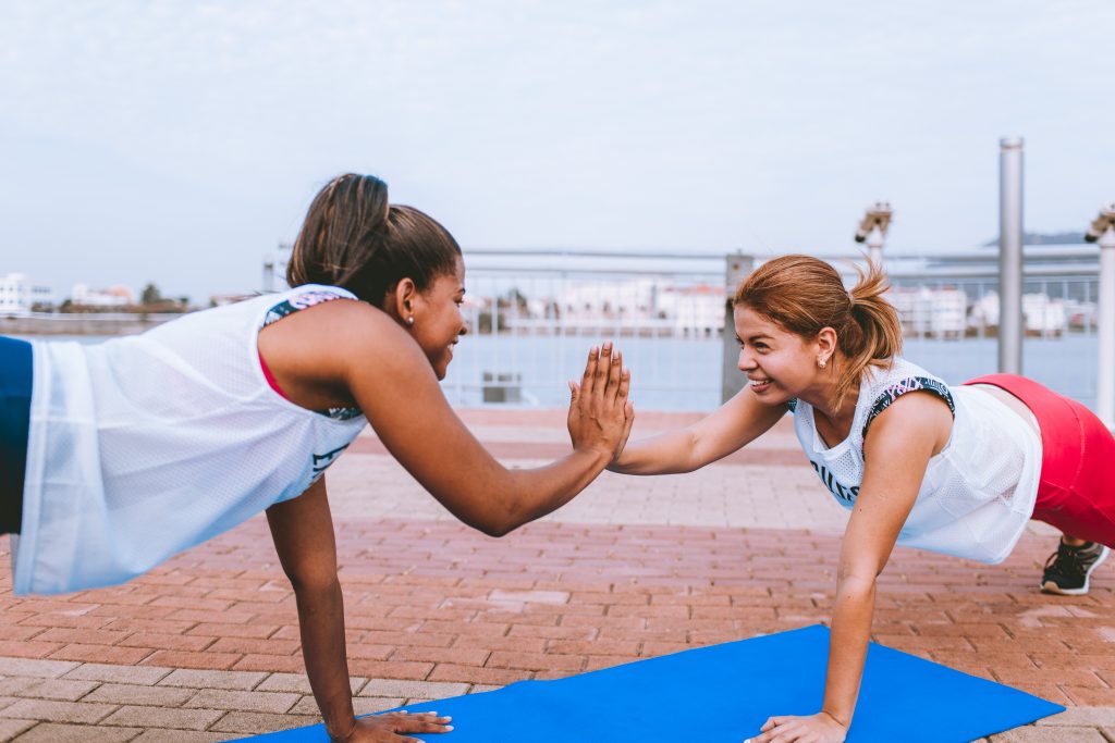 Two friends working out and forming healthy habits.