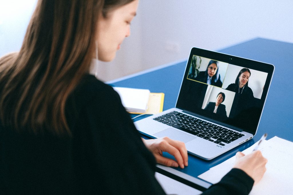 Woman working from home on a video conference call on her laptop. WFH