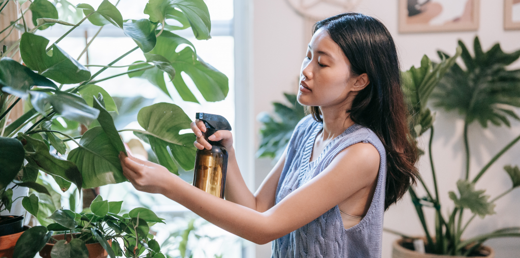 Woman watering her plants on her journey toward self-improvement