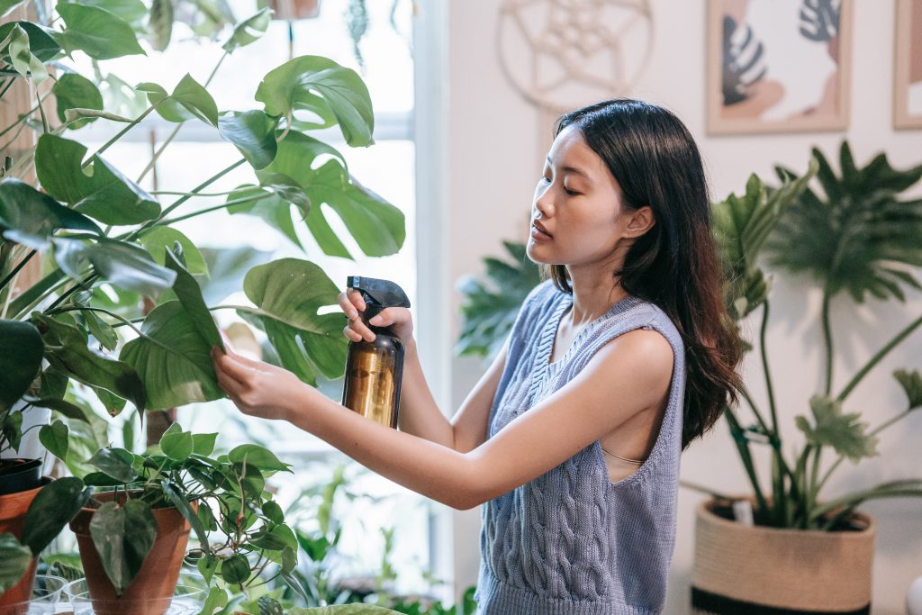 Woman watering her plants on her journey toward self-improvement